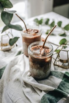 two jars filled with food sitting on top of a table