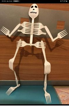 the skeleton is holding two forks in it's arms