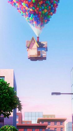 a house floating in the air with balloons attached to it