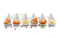 an assortment of different types of food in white dishes