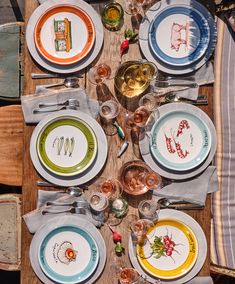 the table is set with plates and glasses