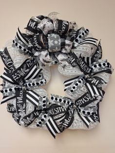 a black and white christmas wreath on a wall