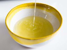 a yellow and white bowl filled with liquid