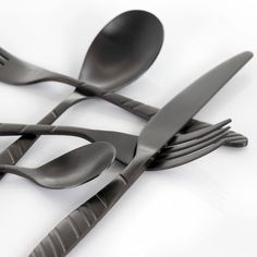 four forks and two spoons on a white surface