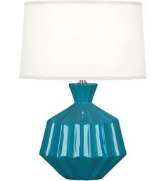 a blue table lamp with a white shade on the base and a light in the middle