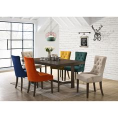 an image of a dining room setting with colorful chairs