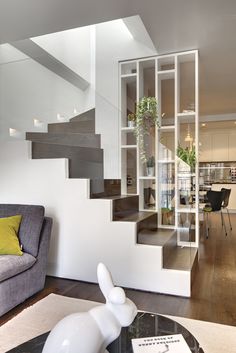 a living room filled with furniture and a stair case