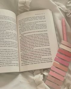 an open book with pink strips on it