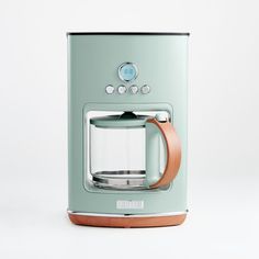 a teal colored coffee maker on a white background