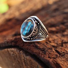 Inspiration: Our Fire Labradorite Antique Silver Ring draws inspiration from ancient myths and legends. It's said that labradorite carries the magical essence of the Northern Lights, and we've captured that enchantment in this exquisite piece. Imagine owning a ring that channels the energy of mystical realms, just like a character from a fantasy novel. Creation Process: Each of these rings is meticulously handcrafted by skilled artisans. We select the finest fire labradorite gemstones and set them in antique silver to create a vintage-inspired masterpiece. The creation process involves a touch of magic and a lot of dedication, resulting in a one-of-a-kind ring. Who Can Wear It: This ring is perfect for women who appreciate unique and meaningful jewelry. It's designed for those who want to Adjustable Mystical Labradorite Rings, Bohemian Round Labradorite Crystal Ring, Mystical Labradorite Rings With Natural Stones, Bohemian Style Labradorite Open Ring, Bohemian Labradorite Open Ring, Bohemian Labradorite Cabochon Rings, Bohemian Blue Labradorite Rings, Spiritual Labradorite Round Ring, Spiritual Labradorite Rings