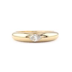 a yellow gold ring with a single diamond