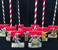 pokemon candles are lined up in rows with characters on them and one candle is lit