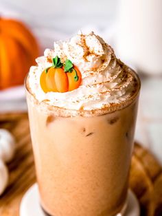 there is a drink with whipped cream and pumpkins on the top, along with marshmallows