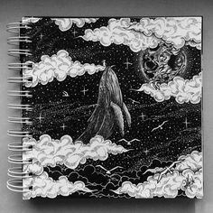 a spiral notebook with an image of a whale in the sky