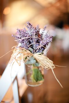 a vase filled with purple flowers on top of a wooden table