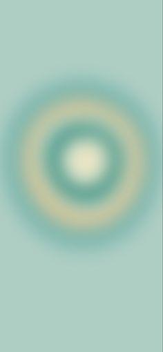 a blurry image of a circular object in the middle of blue and green background