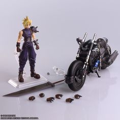 the action figure is being displayed next to a motorcycle with spikes on it's front tire