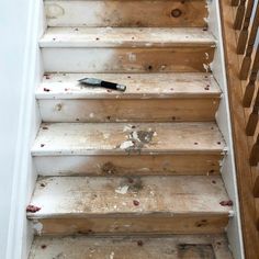 the carpeted stairs have been stripped off and stained white with red stains on them