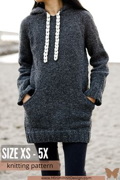 a woman standing on the beach wearing a gray sweater and black leggings, with text overlay that says size xs - 5x knitting pattern