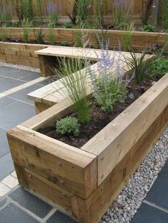 a wooden planter filled with lots of plants