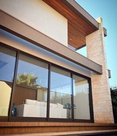 an outside view of a house with large windows