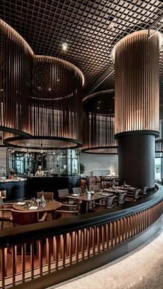 the interior of a restaurant with wooden tables and chairs