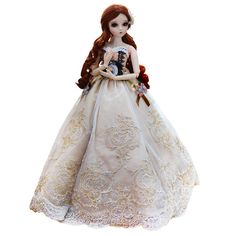 the doll is wearing a white dress and holding a teddy bear in her arms,