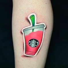 a tattoo on the leg of a woman with a starbucks drink in it's cup