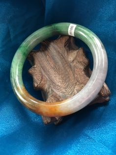 53.76mm Petite Tri-color Green Rust and White CLoud A JADE Jadeite Princess Bangle Bracelet #186 Size: 53.76mm x9.11mm x 9.13mm Weight: 43g = 215 Ct Photos taken in natural lighting. No gem certificate provided with this bangle. Questions? please ask prior to purchase. We provide the original certificate of authenticity; however, we ask that you rely on your own gemologist for value assessment as we do not generate the certificates ourselves. Thank you. Please Note: We are a very small business Multicolor Gemstone Bangle, Jade Bangle, White Cloud, Small Budget, Natural Lighting, Tri Color, Bangle Bracelet, Assessment, Natural Light