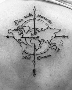 the back of a woman's shoulder with a compass and world map on it