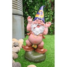 a garden gnome statue sitting in the grass