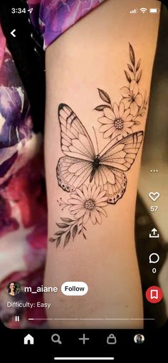 a woman's arm with a butterfly and flowers tattoo on the left side of her arm