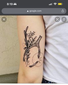 a woman's arm with a tattoo on it that has flowers growing out of it