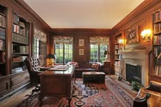 a living room filled with lots of furniture and bookshelves next to a fire place