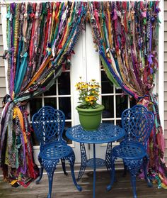 the table is covered with colorful ribbons and potted plants on it's side