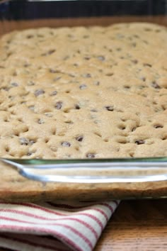 a baking dish filled with cookies on top of a wooden table