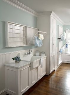 an image of a bathroom with white cabinets and green towels on the rack above the sink