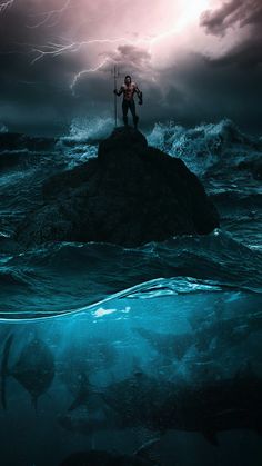 a man standing on top of a rock in the ocean under a lightning filled sky