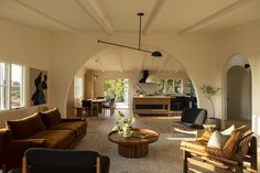 a living room filled with furniture and lots of windows