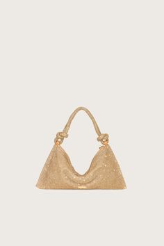 The Hera Shoulder, now available in an even smaller Nano. Crafted from eye-catching gold-hued rhinestone that give a metallic golden shine, this classic design exudes femininity and grace with a knotted shoulder strap and a gorgeously slouchy silhouette. The frosted handheld bag is the perfect addition to add some Gaia sparkle to your life. Glamorous Gold Shoulder Bag For Everyday Use, Luxury Gold Shoulder Bag With Rhinestones, Gold Shoulder Bag With Dust Bag For Evening, Chic Gold Shoulder Bag With Rhinestones, Glamorous Gold Bags With Rhinestones, Glamorous Gold Bags For Everyday Use, Cult Gaia, You Bag, Classic Design