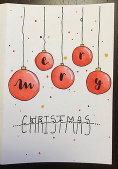 a handmade christmas card with ornaments hanging from it's sides and the words merry written on them