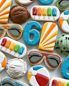 decorated cookies are arranged in the shape of sunglasses, sun glasses, and beach balls