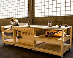 a workbench made out of wood with tools on top and wheels attached to it