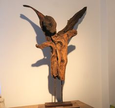 a wooden sculpture on display in a room