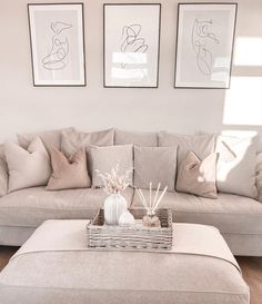 a living room filled with furniture and pictures hanging on the wall above it's coffee table