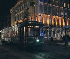 a trolley car on a city street at night