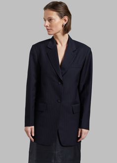 Color: Navy Stripe Midweight woven fabric Relaxed fit Pinstripe pattern Notch lapels Padded shoulders Single illusion breast pocket Inner pocket Button cuffs Front flap pockets Self-tie open back Front button closure Lined 80% Polyester 20% Rayon Dry Clean Imported One Size Pinstripe Business Blazer With Pockets, Tailored Pinstripe Blazer With Pockets, Pinstripe Blazer With Notch Lapel And Pockets, Striped Blazer With Pockets And Lapel Collar, Elegant Striped Blazer With Pockets, Striped Business Casual Blazer With Pockets, Striped Blazer With Pockets For Business Casual, Spring Pinstripe Blazer With Pockets, Pinstripe Blazer With Lapel Collar For Work