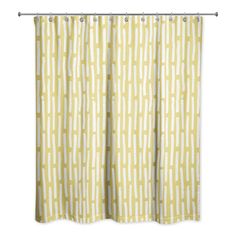 a yellow and white shower curtain hanging from a metal rod with an abstract pattern on it