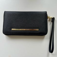 Black Steve Madden Wristlet With Gold Hardware For Those Who Love A Casual Yet Elegant Look Condition: Brand New (Never Wore It But Cut Off The Tags) Fabric Type: Faux Leather, Polyester Dimensions: 8 X 1 X 4 Inches; 8.96 Ounces Closure Type: Zipper Lining: Polyester Inside: One The Front Side: 3 Credit Card Slots + One Id Opposite Side Starts With 3 Compartments (One Opens About 1.5", The Other One For 1") And 1 With Zipper. 6 Credit Card Slots Then One Lined Compartment. Then The Zipper Flat C Wallet Wristlet, Steve Madden Bags, Cut Off, Gold Hardware, Card Slots, Steve Madden, Zip Around Wallet, Slots, Credit Card