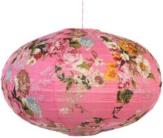 a pink flowered paper lantern hanging from a string